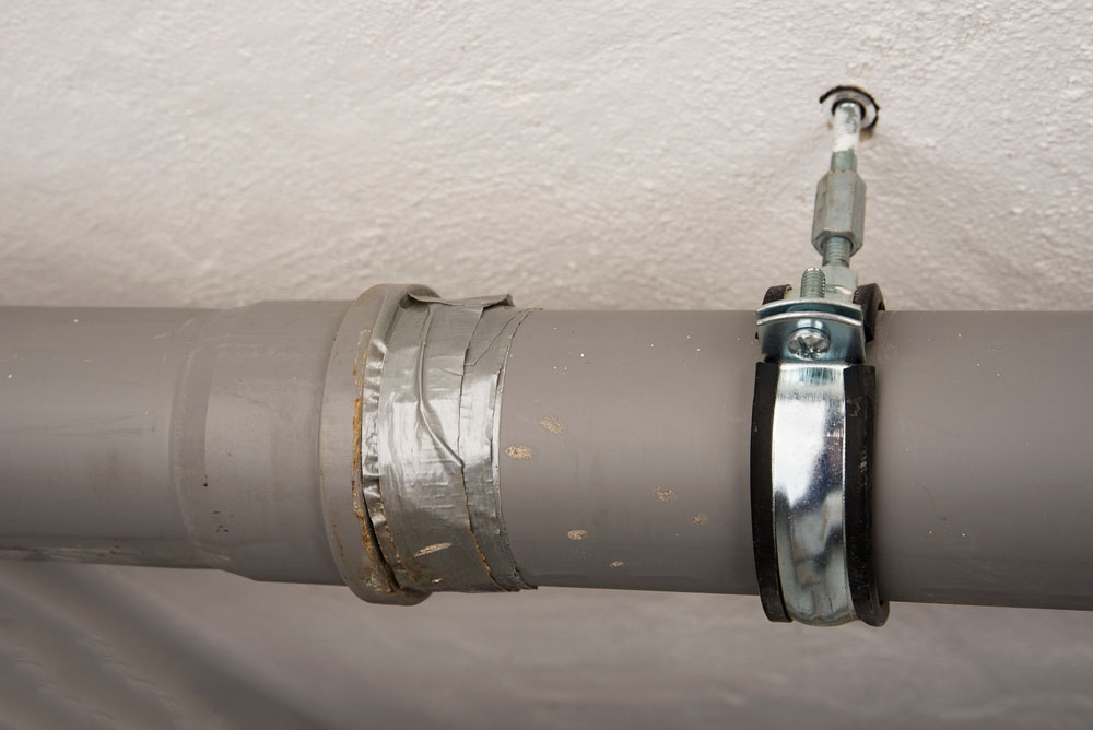 Leaking sewage plastic pipe fixed with a duct tape