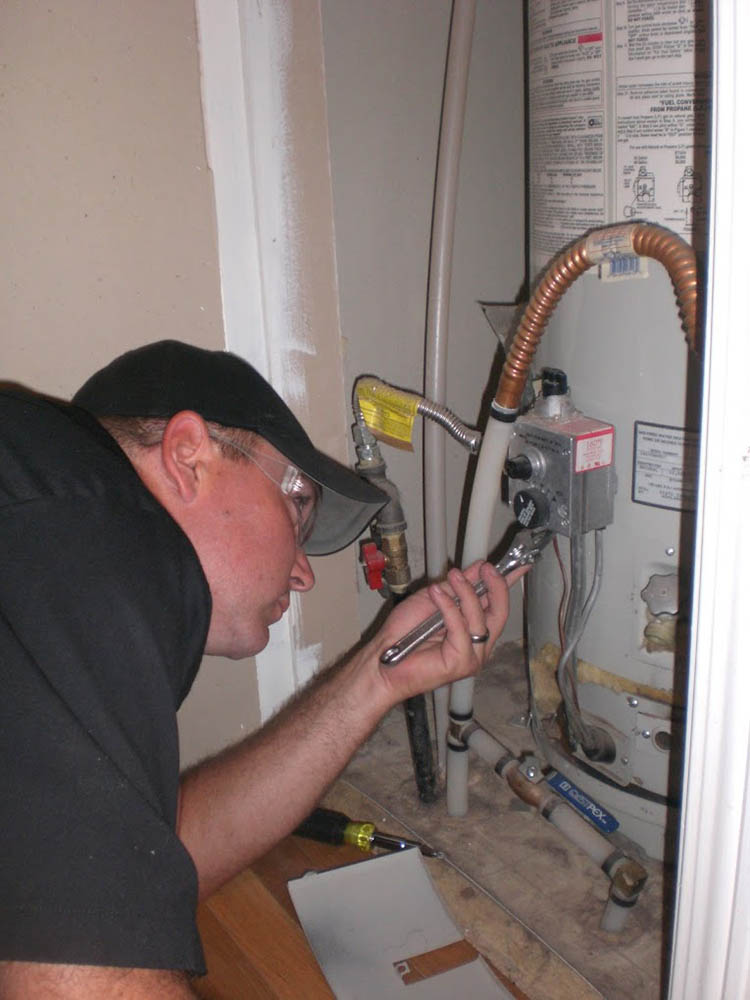 plumber repairing water heater Colorado Springs, CO
