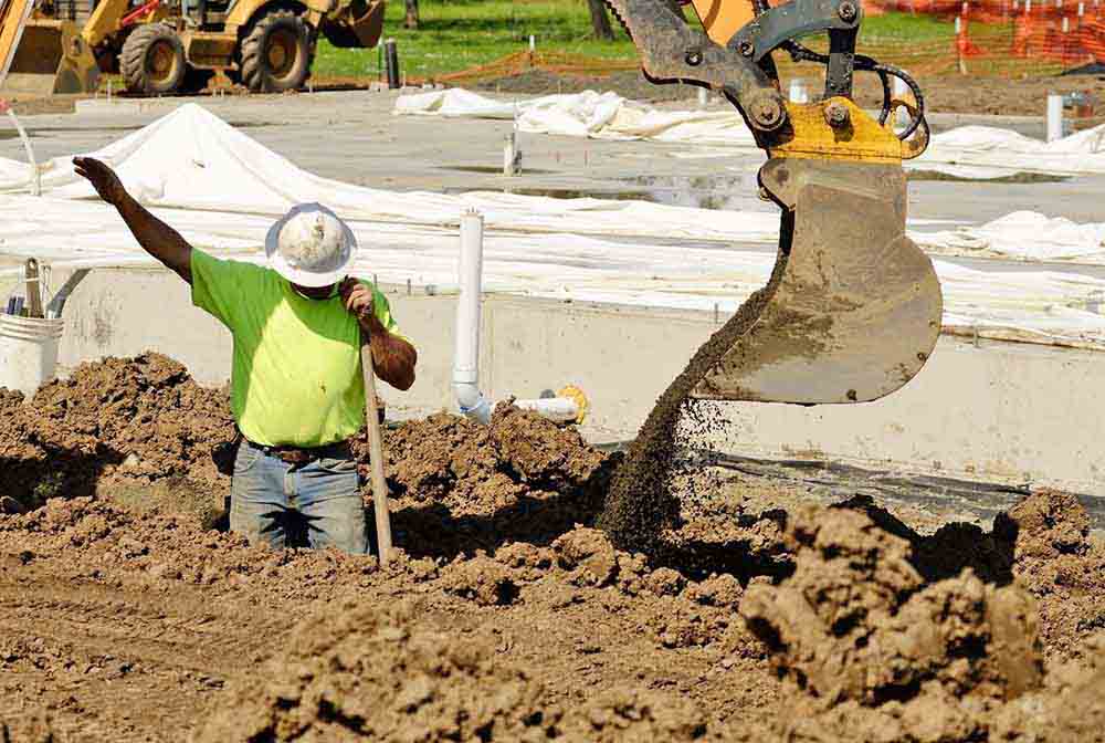 plumbers in the middle of a residential excavation pipe repair project